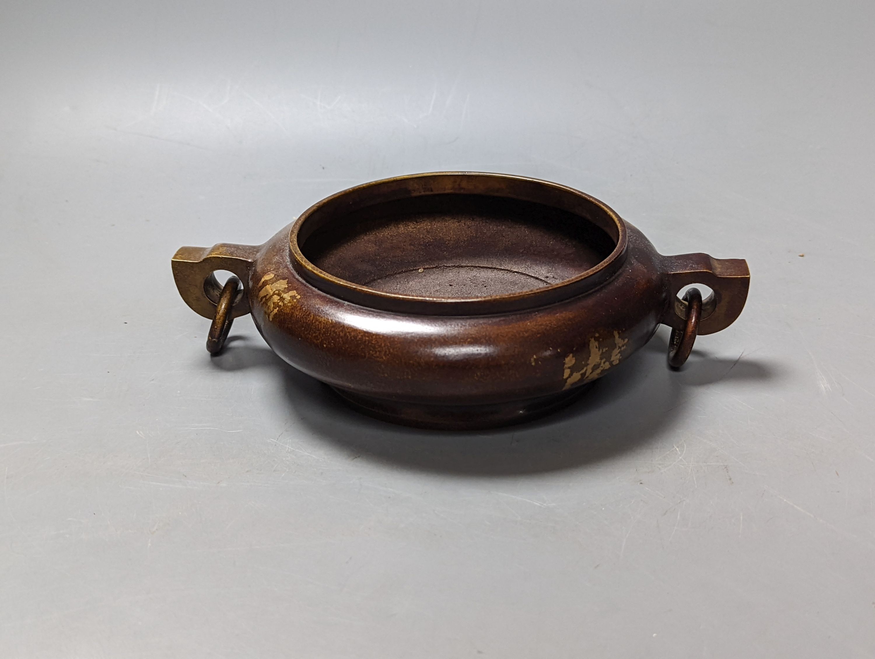 A Chinese gold splashed bronze censer, 22 cms high.